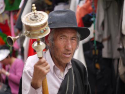 Old man spinning prayer wheel in Barkhor, Lhasa