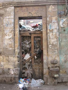 Entrance of a ruined house in Old Cairo, now completely
	 filled with garbage