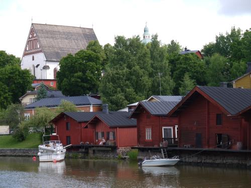 Landmark red wooden houses, church in the background, Porvoo
